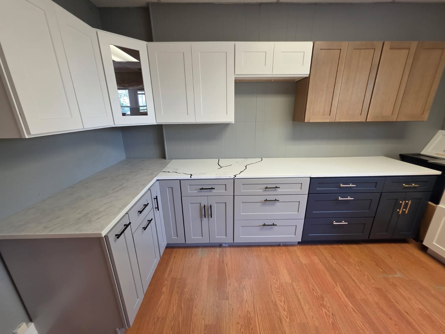 Two-tone: white uppers, navy & oak below — A&J Cabinet Studio install